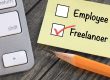 pencil and calculator next to checklist that says employee and freelancer with a checked box next to freelancer