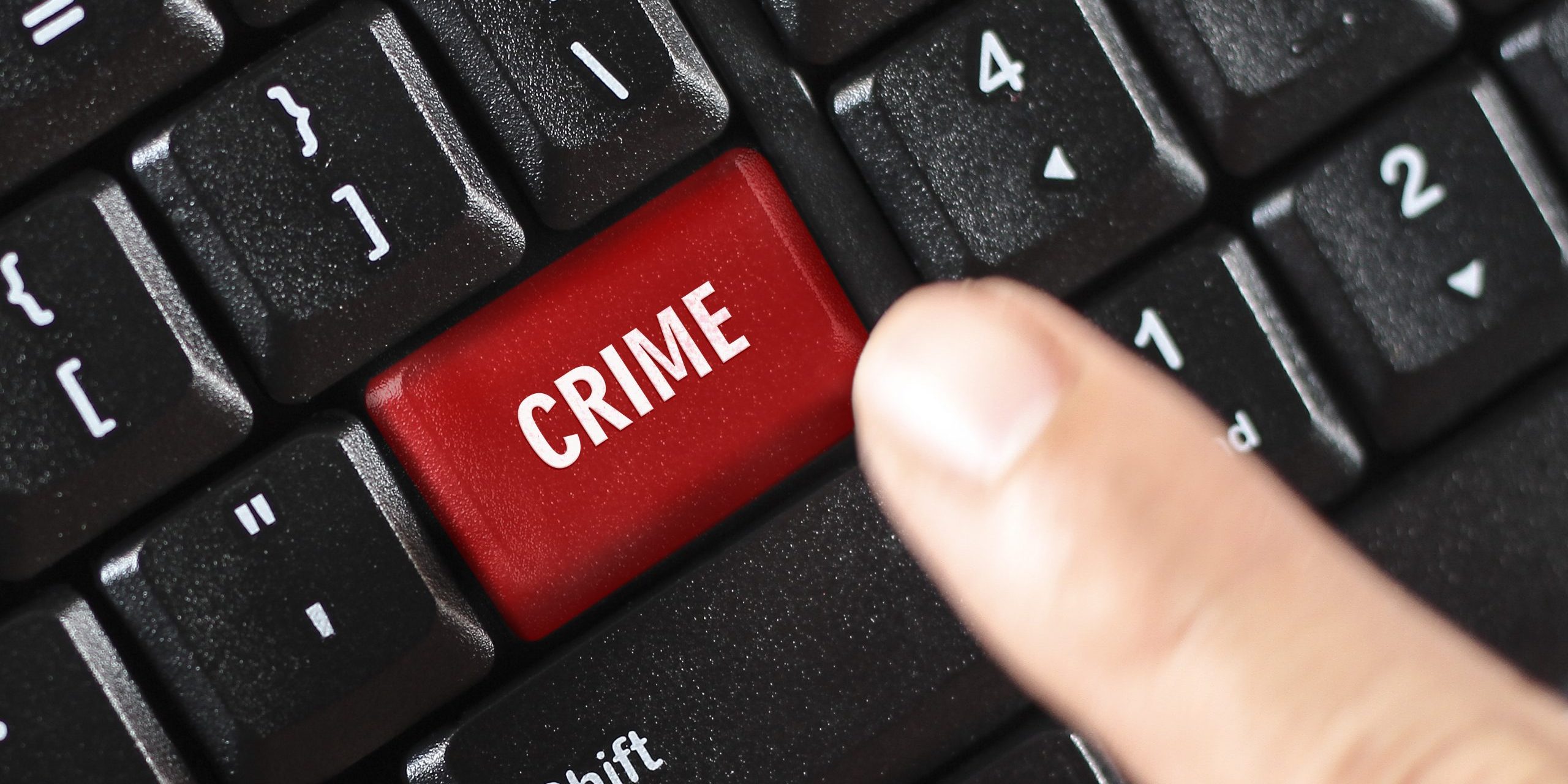 Crime key on a computer keyboard being pressed