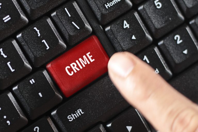 Crime key on a computer keyboard being pressed